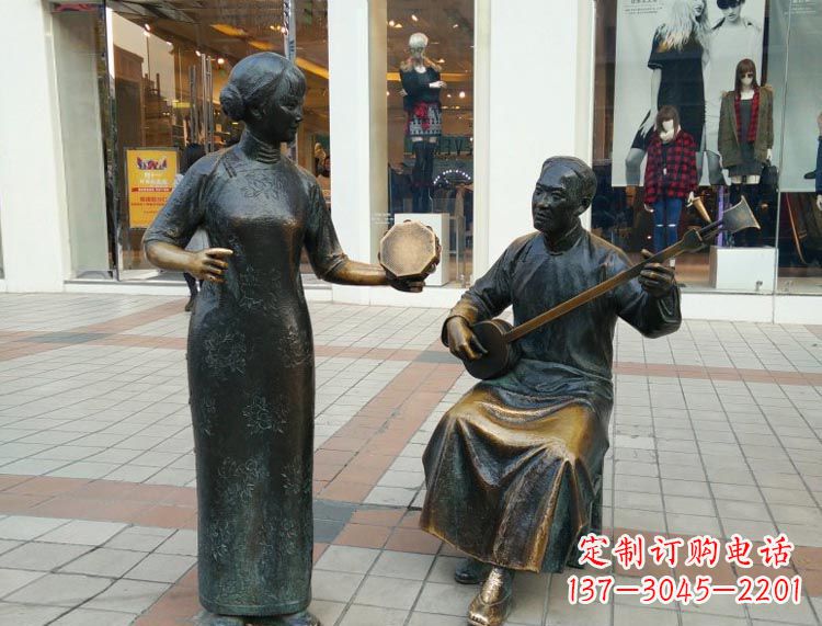 弹三弦敲手鼓的人物铜雕